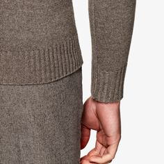 This soft taupe knitted sweater is
 tailored slim with a ribbed hem and cuffs, and heavy turtleneck collar. Formal Wool Sweater With Ribbed Cuffs, Formal Winter Sweater With Ribbed Collar, Cashmere Workwear Turtleneck With Ribbed Cuffs, High Neck Cashmere Sweater For Work, Cashmere Turtleneck With Ribbed Cuffs For Work, Fitted Classic Cashmere Polo Sweater, Formal Wool Sweater With Ribbed Collar, Elegant Formal Polo Sweater For Fall, Winter Beige Sweater For Formal Occasions