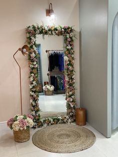 there is a mirror with flowers on it in the room next to a rug and lamp