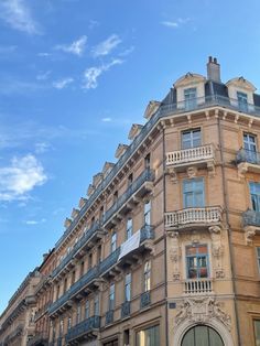 an old building with balconies on the top floor