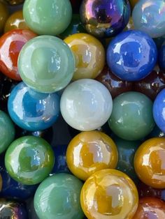 many different colored marbles are stacked on top of each other in the same pattern