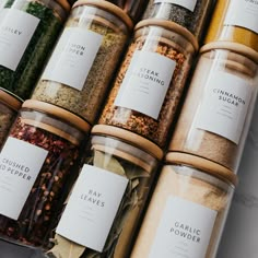 the jars are filled with different types of spices and seasonings, including peppercorst