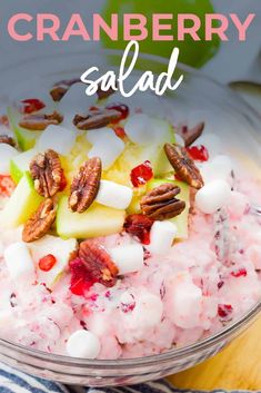 cranberry salad in a glass bowl with pecans and apples on the side