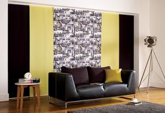 a modern living room with black and yellow curtains, grey leather sofa and wooden flooring