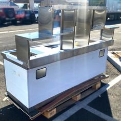 a food cart sitting in the middle of a parking lot