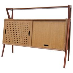 a wooden cabinet with perforated holes on the front and sides, against a white background