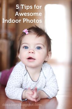 a baby is sitting on the floor and looking up