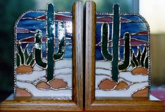 two stained glass pieces with cactus designs on them