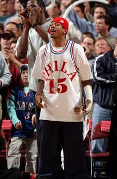 two young men standing next to each other at a basketball game