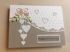 an anniversary card with hearts hanging from it