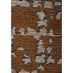 a brown and blue rug with white dots on the bottom, in an abstract pattern