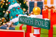 a street sign that says north pole in front of christmas presents