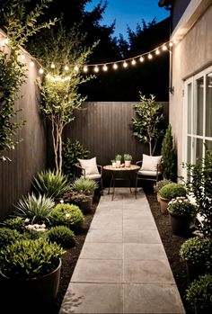 an outdoor patio with potted plants and lights