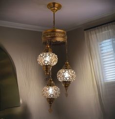 three lights hanging from a ceiling in a room