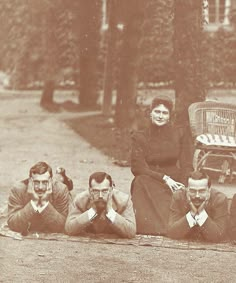 an old black and white photo of people laying on the ground