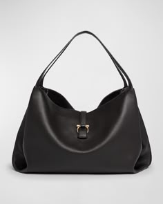 "This Ferragamo tote bag is crafted from leather. It features shoulder straps, an open top with a center Gancini strap, and one zip pocket on the interior. The bag measures approximately 15.4\"H x 20.5\"W x 7.1\"D and is made in Italy." Uni Bag, Ferragamo Bag, Salvatore Ferragamo Bags, Large Leather Tote Bag, Designer Tote Bags, College Bags, Large Leather Tote, Designer Totes, Pocket Bag