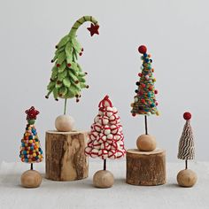 small wooden christmas trees on top of logs