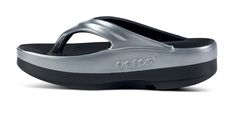 The OOmega OOlala is a versatile, modern take on the traditional OOlala active recovery sandal. Still featuring the same proprietary OOfoam™ technology and patented footbed design - the addition of the MEGA midsole gives you an extra 15mm of impact-absorbing OOfoam™ technology. The OOmega is a step forward in fashion and another step into active recovery. OOmega, a women’s platform sandal for trend-setting recovery, day or night. Unique in footwear and only from OOFOS. Stack: Elevated color comb Recovery Sandals, Active Recovery, Black Basalt, Elevated Style, Platform Sandals, Color Combos, Comb, In Fashion, Technology