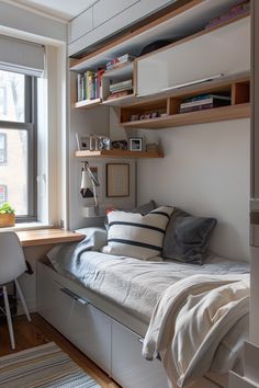 a small bedroom with a bed, desk and bookshelf in the window sill