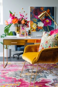 a living room filled with furniture and flowers on top of a colorful rug in front of a desk