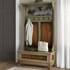 an old wooden bench and coat rack in a room