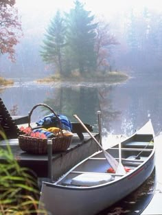 there is a small boat on the water with a basket full of fruit in it