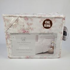 the packaging for this bedding set is white with pink flowers on it and has a brown tag that says cat king