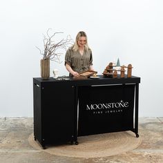 a woman sitting at a table with some items on it