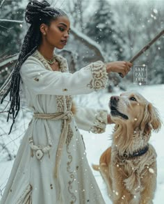 a woman in white dress petting a golden retriever dog on snow covered ground