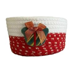 a red and white basket with a bow on it