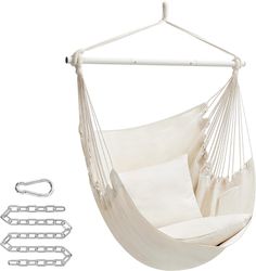 a white hammock hanging from the ceiling with two pillows and clips to hang it