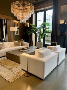 a living room filled with furniture and a chandelier