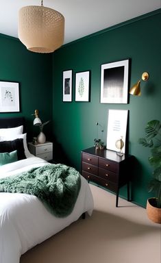 a bedroom with green walls and pictures on the wall