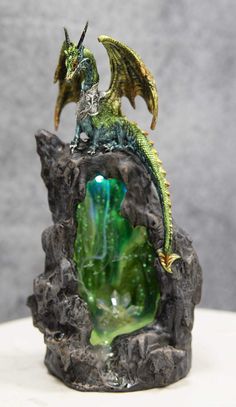 PRICES MAY VARY. This Armored Green Quartz Cave Climbing Dragon Backflow Incense Cones Burner With LED Light Statue stands at 11.25" tall, 5.5" long and 4.25" deep approximately. It weighs about 2.25" pounds. This Armored Green Quartz Cave Climbing Dragon Backflow Incense Cones Burner With LED light Statue is made of designer composite resin, hand painted and polished individually. Backflow incense cones are needed for this item and they are sold separately in our store in 4 different scents; Ro Cave Climbing, Armored Dragon, Emerald Dragon, Geode Cave, Dragon Incense Burner, Dragon Light, Fairytale Decor, Backflow Incense Burner, Incense Cone