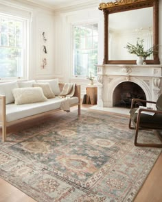 a living room filled with furniture and a fire place in front of a mirror on the wall