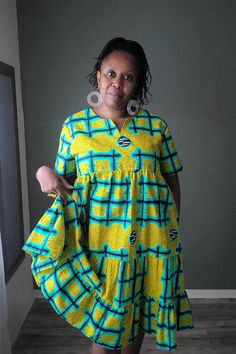 This roomy African print cotton summer dress will be one of your favorites this summer.  Fit: Relaxed Details:  - Dropped armholes - one button back closure - In seam side pockets Garments Measurements: MEDIUM Bust: 46 in Waist:  46 in Hips:  FREE Sleeve Length: 9 in Full Length: 42 in LARGE Bust: 48 in Waist:  48 in Hips:  FREE Sleeve Length: 9 in Full Length: 42 in READY TO SHIP IN 5 DAYS Machine Washable (cold with like colors suggested) and Dryer Safe  Hand wash is better to preserve the bri Cotton Short Sleeve Sundress, Multicolor Cotton Sundress With Short Sleeves, Yellow Cotton Knee-length Sundress, Yellow Cotton Midi Dress With Short Sleeves, Yellow Cotton Sundress With Short Sleeves, African Print Dress Ankara, Best African Dresses, African Dresses Modern, African Print Dress Designs