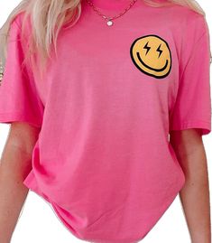 Electric Smiles Tee | Sassy Shortcake | sassyshortcake.com Cute Pink Smiley Face Top, Fun Pink Smiley Face Tops, Trendy Smiley Face Crew Neck T-shirt, Trendy Crew Neck T-shirt With Smiley Face, Fun Pink Tops With Smiley Face, Casual Smiley Face Short Sleeve Tops, Trendy Smiley Face Summer Tops, Trendy Pink Smiley Face Tops, Cute Short Sleeve Top With Smiley Face