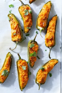 several stuffed peppers are on a tray ready to be cooked