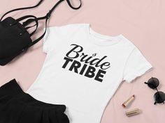 👰 Bridal Party Perfection: Elevate your bridal party with these thoughtful t-shirts, designed for comfort and style. Whether you're celebrating at a bachelorette party, rehearsal dinner, or on the big day itself, these tees are the perfect choice for a united and chic bridal party ensemble. ✨ Luxuriously soft, crafted from 100% cotton for solid colors, this tee guarantees ultimate comfort. 💪 Enhanced durability with twill tape on the shoulders and no bothersome side seams. 🌀 The ribbed knitti Cheap White T-shirt For Bachelorette Party, Chic Bridal Party, Rehearsal Dinners, Rehearsal Dinner, Versatile Style, Twill Tape, Lightweight Fabric, Semi Formal, Bachelorette Party