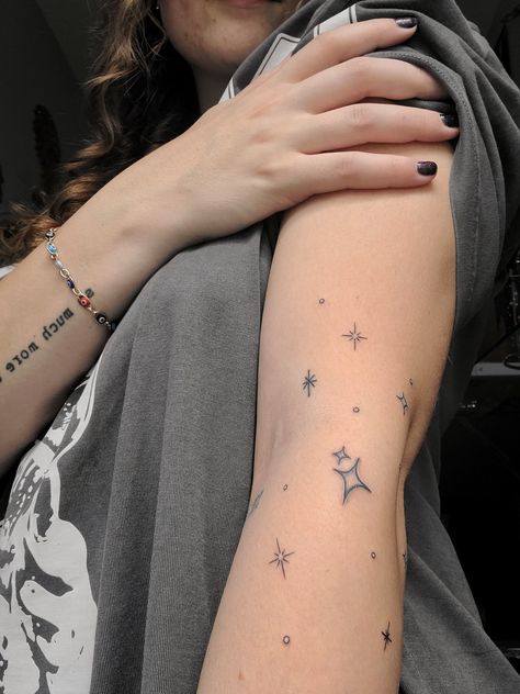 Star tattoo on arm Tiny Stars Tattoo Arm, Stars Around Moon Tattoo, Scattered Star Tattoos, Sparkle Tattoo Sleeve Filler, Star Patchwork Tattoos, Anime Star Tattoo, Star Hip Tattoos Women, Star Arm Band Tattoo, Star Tattoo Sleeve Women