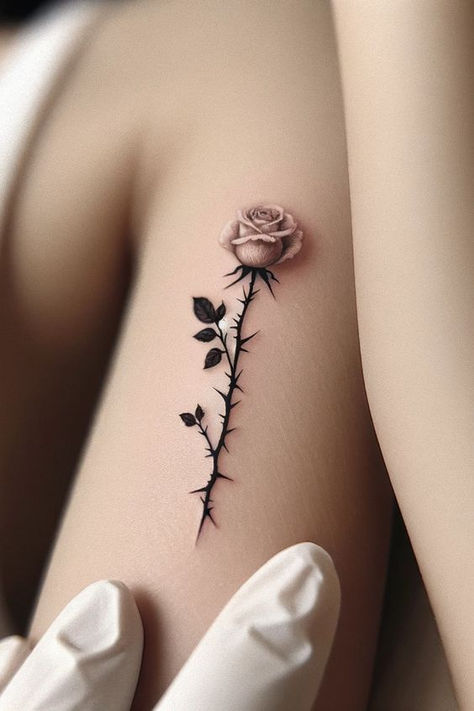 Tattoo Flower Designs For Women, Tattoo For Older Women, Rose And Angel Wing Tattoo, Hand Rose Tattoos For Women, Beauty Tattoo Ideas For Women, Rose Floral Tattoo Design, Rose Tattoo Ideas Female, 50 Tattoos For Women, Closed Rose Tattoo