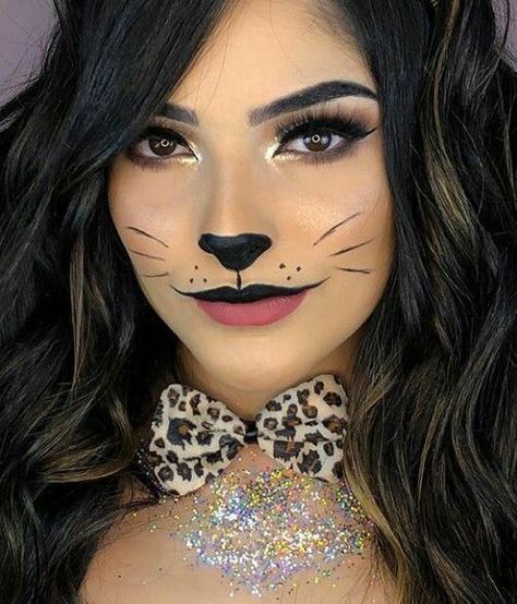 "Get ready to turn heads this Halloween with a fierce and stylish leopard costume! This wild and glamorous look is easy to create with a leopard print bodysuit, dress, or jumpsuit. Add cat ears, a tail, and leopard-inspired face makeup with bold eyeliner, whiskers, and spots to complete your transformation. Perfect for anyone looking for a fun yet fashionable costume, the leopard look is versatile and can be accessorized with dramatic nails, bold eye makeup, and statement heels. Cheetah Print Face Makeup, Cheetah Print Halloween, Cheetah Makeup Halloween, Makeup Cheetah, Cat Eye Makeup Halloween, Leopard Makeup Halloween, Leopard Halloween Costume, Cat Costume Makeup, Cat Face Paint