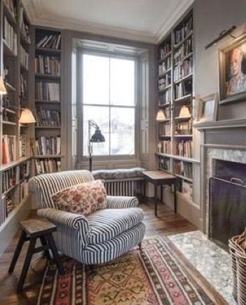 Cozy home library with fireplace and striped arm chair Home Library With Fireplace, Small Home Library, Home Library Design Ideas, Library With Fireplace, Reading Room Decor, Cozy Home Library, Home Library Rooms, Cozy Library, Home Library Design