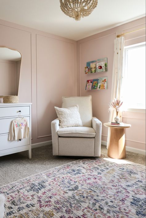 Light Pink Nursery Accent Wall, Floral Pink Nursery, Baby Girl Nursery Pink Walls, Light Mauve Nursery, Acrylic Book Shelves In Nursery, Soft Feminine Nursery, Neutral Nursery With Pops Of Pink, Nursery Acrylic Shelves, Pale Pink Nursery Walls