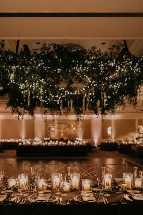 Glowy evening wedding reception with stunning lush greenery installation and romantic candlelit tablescapes at elegant ballroom bash at Nemacolin in Farmington, Pennsylvania. Dream turned reality by Florist- Luxe Creative, Planner- Bumble Burgh Events Co. and Photographer- Rachel Rowland. Wedding Ballroom Lighting, Romantic Evening Wedding Decor, Romantic Greenery Wedding Decor, Wedding Ballroom Decorations Receptions, Twinkle Lights Ballroom Wedding, Wedding Reception Ballroom Decor, Wedding In Ballroom, Winter Wedding Ballroom, Mood Lighting Wedding