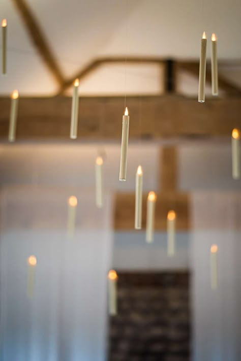 Image shows a Harry Potter themed wedding with hanging candles throughout the ceiling at Farbridge Barns. Photo credit Lucy Davis Photography Candle Hanging From Ceiling, Floating Candles Wedding Harry Potter, Harry Potter Candle Holder, Floating Candle Wall, Halloween Decor Hanging From Ceiling, Floating Candle Harry Potter, Floating Ceiling Candles, How To Hang Candles From Ceiling, Flying Candles Harry Potter