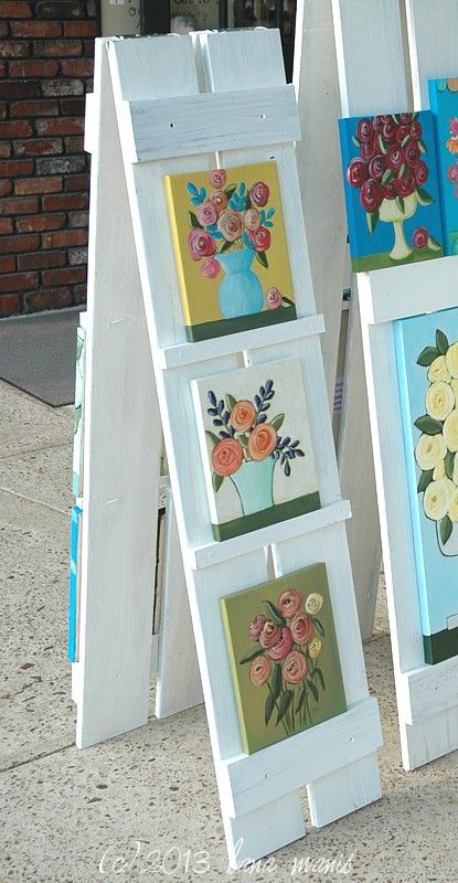 shutter easel lana manis Vertical Display Ideas, Displaying Coasters For Sale, Creative Ways To Display Artwork, Plywood Display Wall, Outdoor Display Exhibition, How To Display Vinyl Decals To Sell, Backyard Boutique Ideas, Car Charm Vendor Display, Diy Trade Show Display