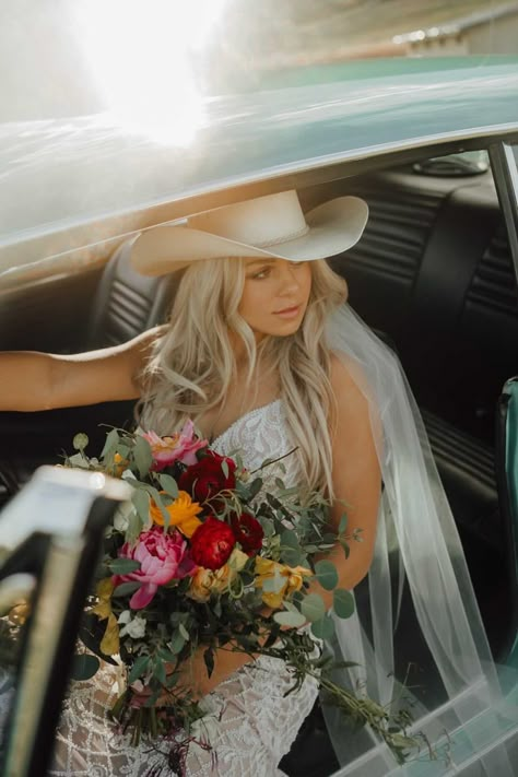 Stunning bride in cowgirl hat sitting in vintage car - Montana wedding inspiration - bride style Cowgirl Hat Wedding Dress, Cowgirl Wedding Hat, White Cowboy Hat Wedding, Cowgirl Hat Veil, Bride With Cowboy Hat, Western Bride Photoshoot, Wedding Hair With Cowboy Hat, Cowboy Hat Veil, Wedding Dresses Western Style