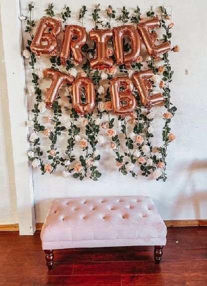 20 Simple Bride To Be Party Decoration Ideas At Home 2024 Photo Wall Bridal Shower Ideas, Bridal Shower Decorations Backdrop, Hens Party Photo Backdrop, Diy Bridal Shower Photo Backdrop, Floral Bridal Shower Photo Backdrop, Simple Floral Bridal Shower Decor, Hen Party Photo Wall, Photo Booth Bridal Shower Ideas, Bridal Shower Tea Party Backdrop