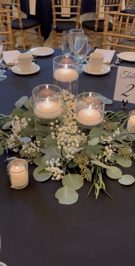 No Flowers Centerpieces Wedding, Low Eucalyptus Centerpiece, Candle Table Arrangements, Inexpensive Round Table Centerpieces, Greens And Candles Centerpieces, Floating Candle Centrepiece, Vases And Candles Centerpieces, Simple Affordable Wedding Centerpieces, Flameless Wedding Centerpieces