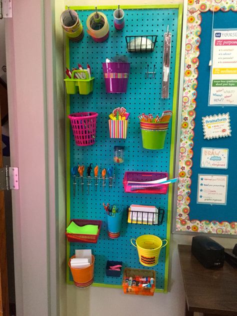 A fun way to use peg boards to organize supplies in the classroom. I drilled holes in the back of some of these bins and buckets and attached them with zip ties Pegboard Organization Classroom, Peg Board Ideas Classroom, Peg Board Classroom, Peg Board Classroom Ideas, Classroom Wishlist, Preschool Room, Peg Boards, Dream Classroom, Preschool Rooms